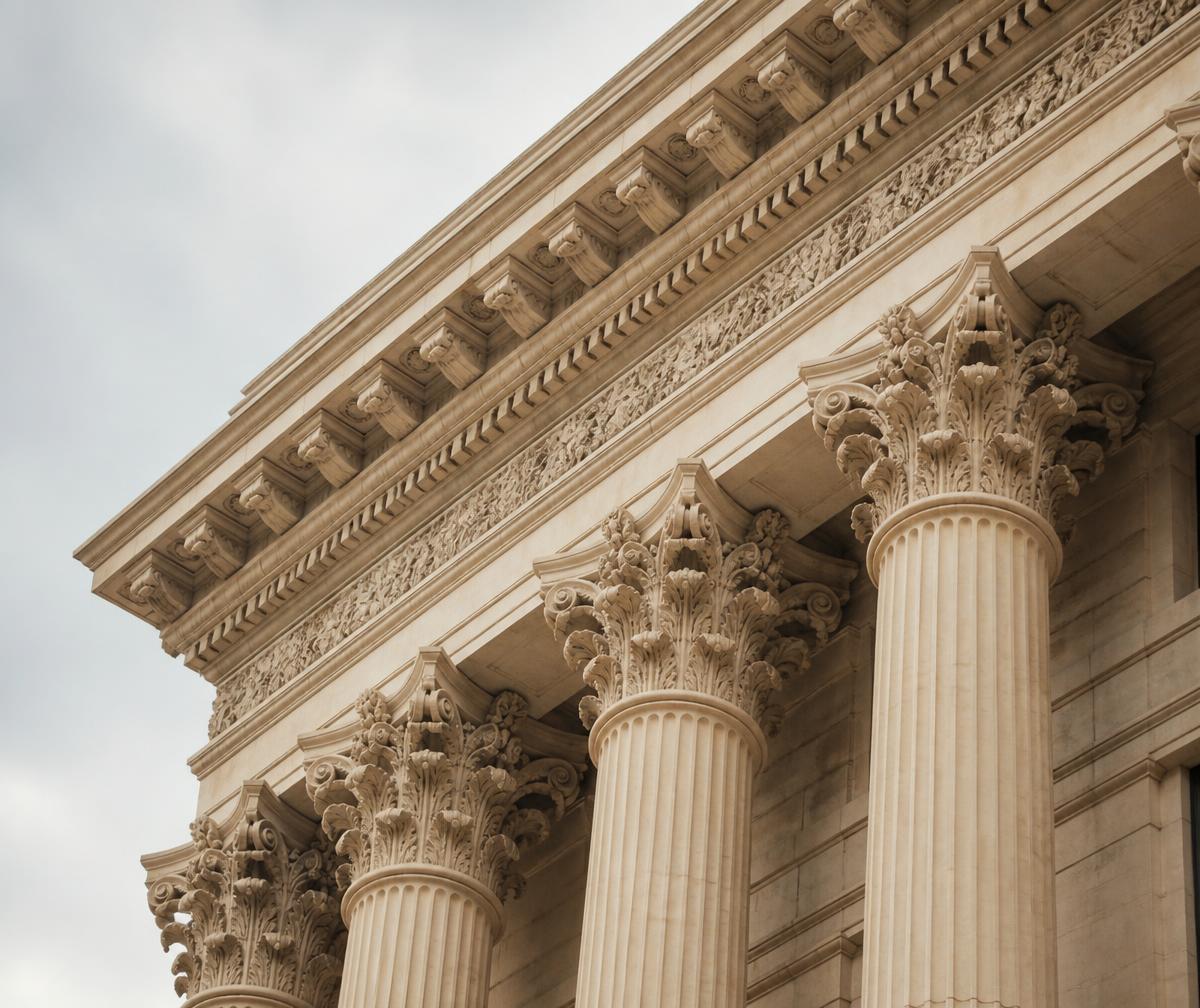 Classical stone cornice and Corinthian columns in warm limestone